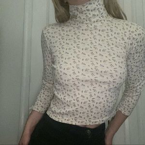 Super cute white floral turtleneck.